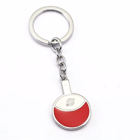 Donnez une touche Ninja à vos clés avec ce porte-clé Naruto métallique représentant le symbole des Uchiwa, l'accessoire idéal pour les fans du manga !